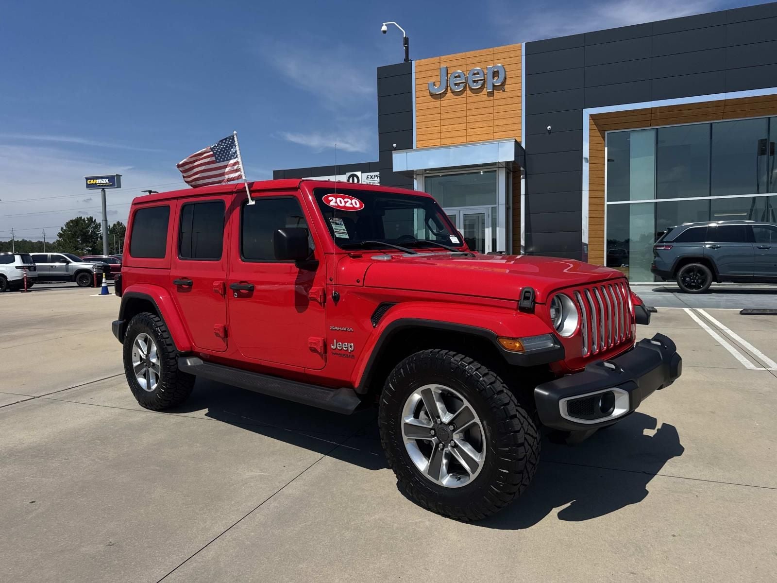 2020 Jeep Wrangler Unlimited Sahara 4x4 in Firecracker Red Clearcoat — front three-quarter view