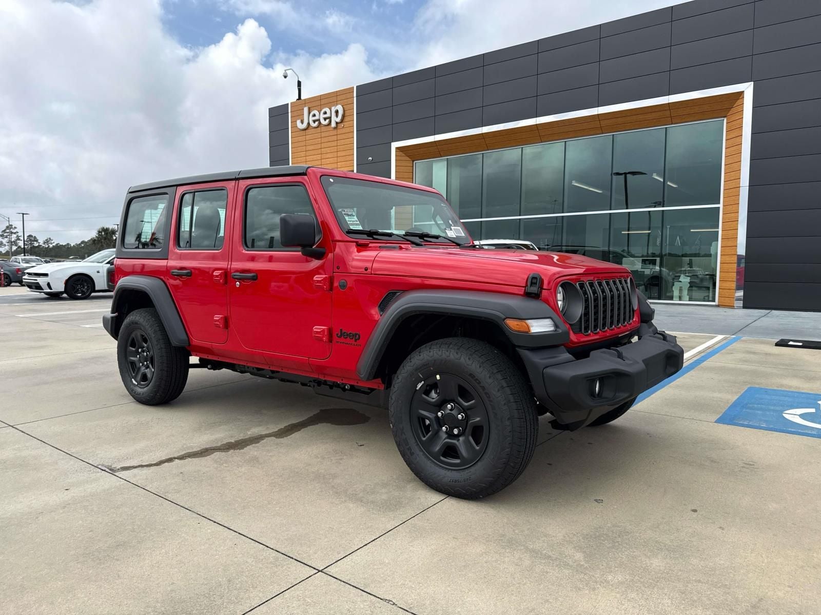 2026 Jeep Wrangler WRANGLER 4-DOOR SPORT in Firecracker Red Clear-Coat Exterior Paint — front three-quarter view
