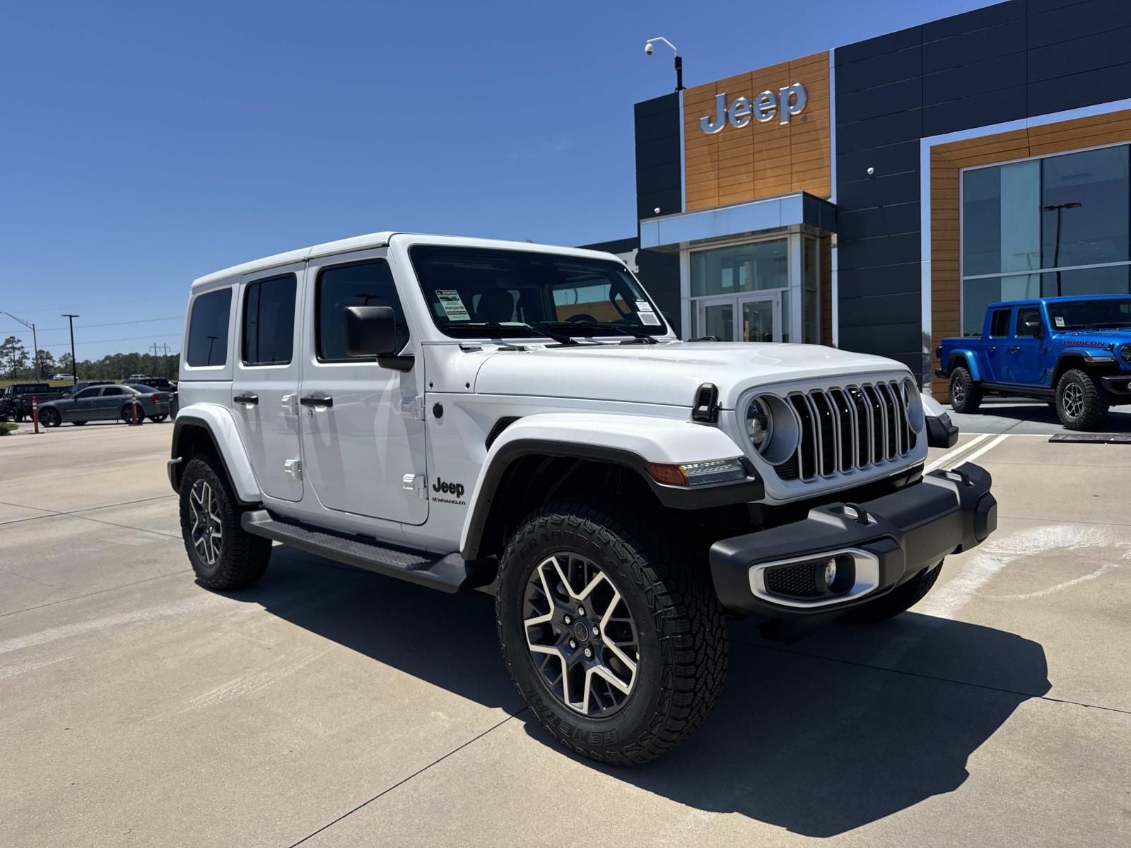 2026 Jeep Wrangler WRANGLER 4-DOOR SAHARA in Bright White Clear-Coat Exterior Paint — front three-quarter view