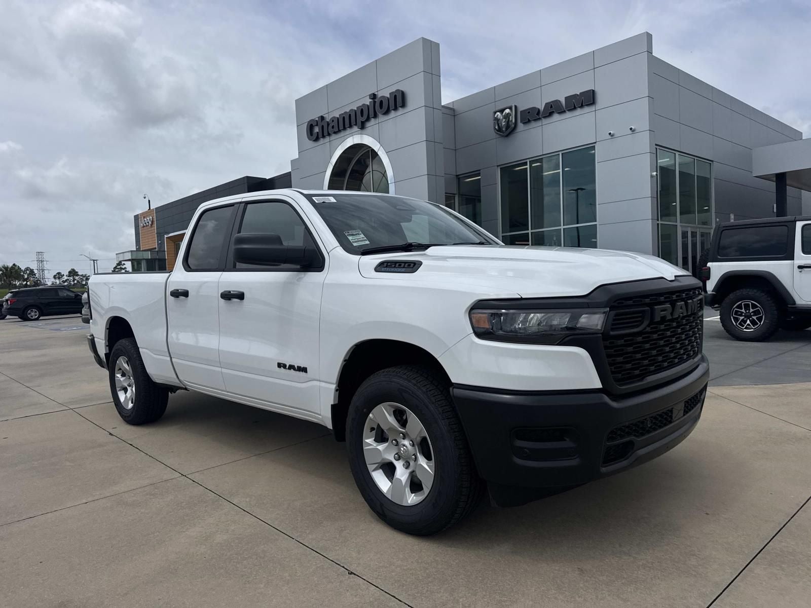 2026 RAM Ram 1500 RAM 1500 TRADESMAN QUAD CAB 4X4 6'4' BOX in Bright White Clear-Coat Exterior Paint — front three-quarter view