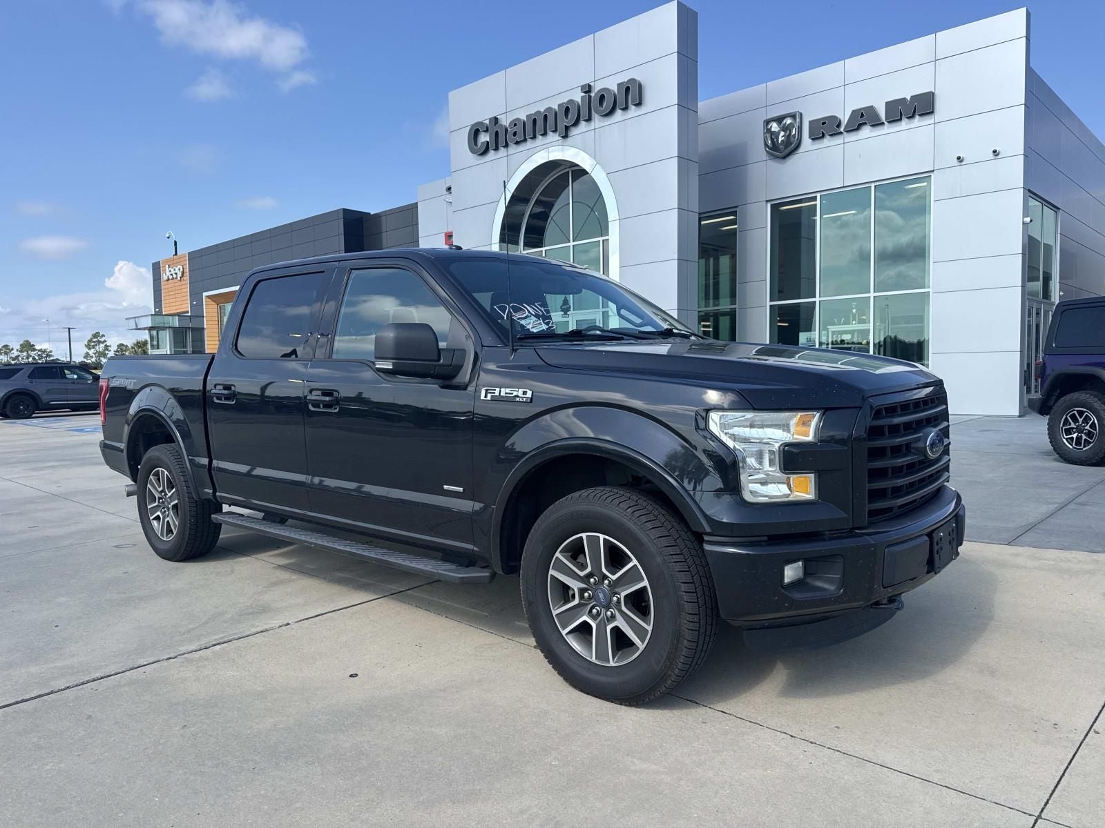 2015 Ford F-150 LARIAT in Tuxedo Black Metallic — front three-quarter view