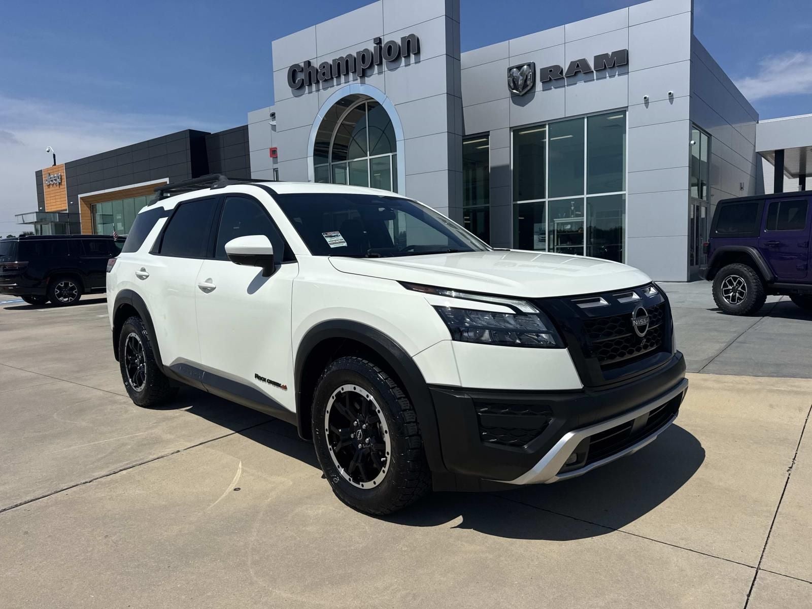 2024 Nissan Pathfinder Rock Creek 4WD in Glacier White — front three-quarter view